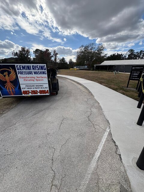 Gemini Rising's branded trailer parked beside a bright, freshly washed sidewalk at Oviedo City Church
