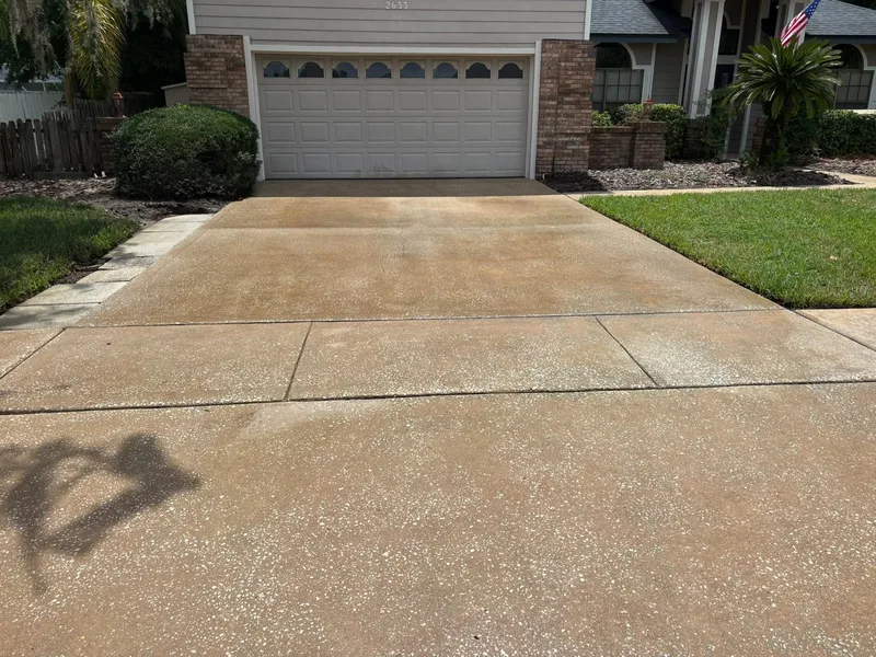 Same driveway uniformly bright and clean after pressure washing
